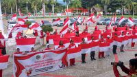 Pemkab Parimo Resmi Laksanakan Gernas Pembagian Bendera Merah Putih